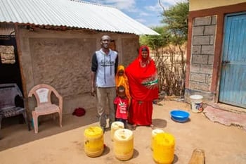 Family with water in Kenya - UNICEF